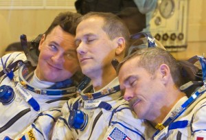 International Space Station crew members Russian cosmonaut Romanenko, U.S. astronaut Marshburn and Canadian astronaut Hadfield joke as they talk with relatives after putting on their space suits at the Baikonur cosmodrome